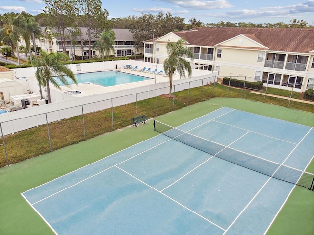view of sport court with a community pool