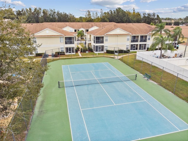 view of sport court featuring a lawn