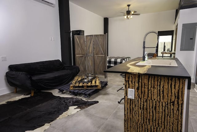 living room featuring electric panel, light tile patterned floors, sink, and ceiling fan