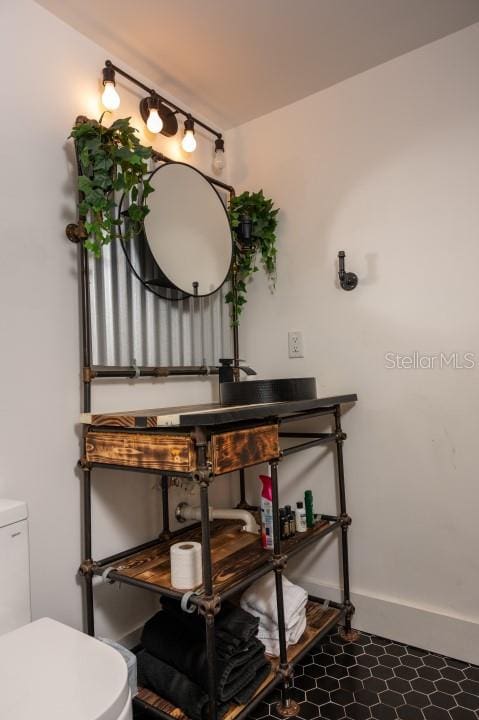 bathroom featuring tile patterned flooring and toilet