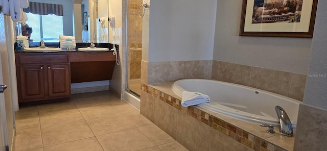 bathroom featuring plus walk in shower, dual vanity, and tile flooring