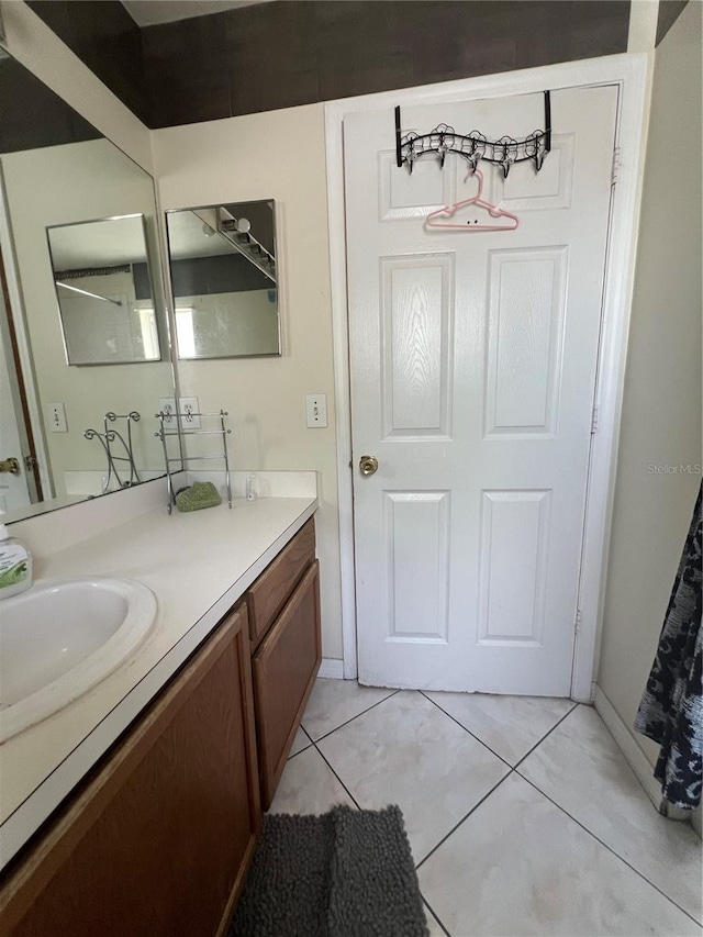 bathroom featuring tile flooring and vanity