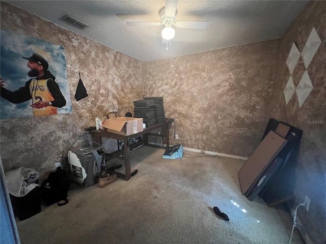 interior space with a textured ceiling and ceiling fan