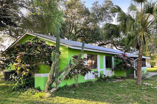 view of side of home featuring a yard