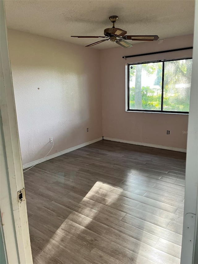 unfurnished room with a textured ceiling, ceiling fan, and light wood-type flooring