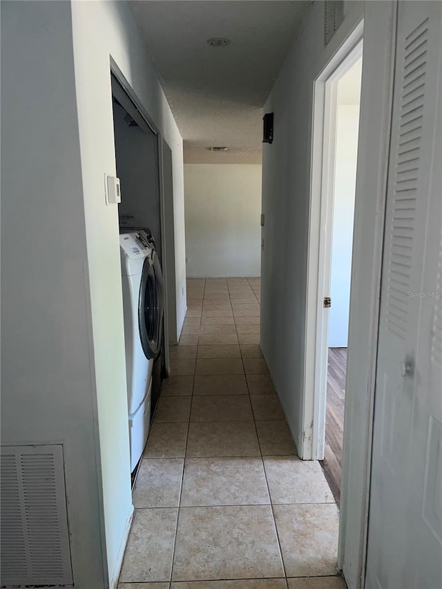 washroom with washer / dryer, laundry area, visible vents, and light tile patterned floors