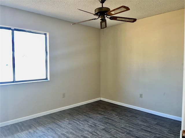 unfurnished room featuring a textured ceiling, dark wood finished floors, a ceiling fan, and baseboards