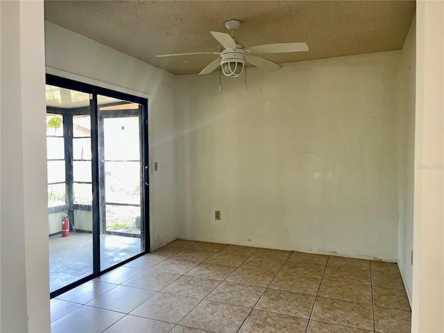 unfurnished room featuring a healthy amount of sunlight, ceiling fan, and light tile patterned floors