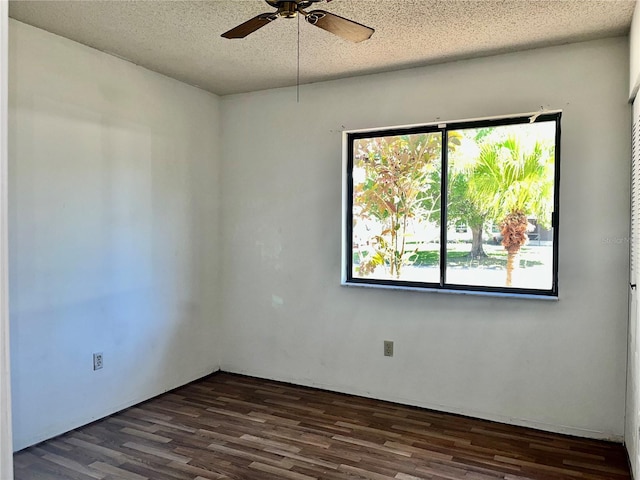 unfurnished room with dark wood-style floors, a textured ceiling, and a ceiling fan