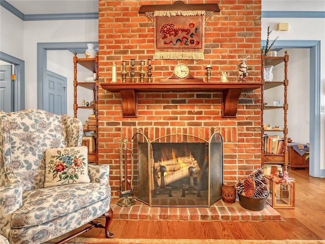 details with ornamental molding, light wood-type flooring, and a fireplace