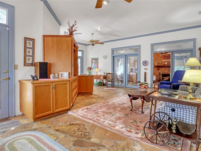 tiled living room featuring crown molding, a brick fireplace, ceiling fan, and brick wall