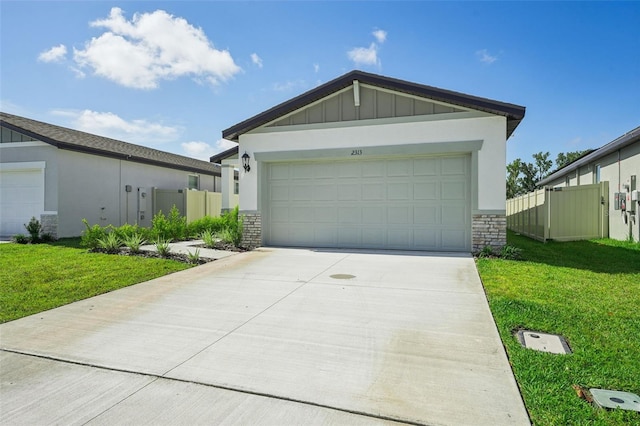 view of front of home featuring a front yard and a garage