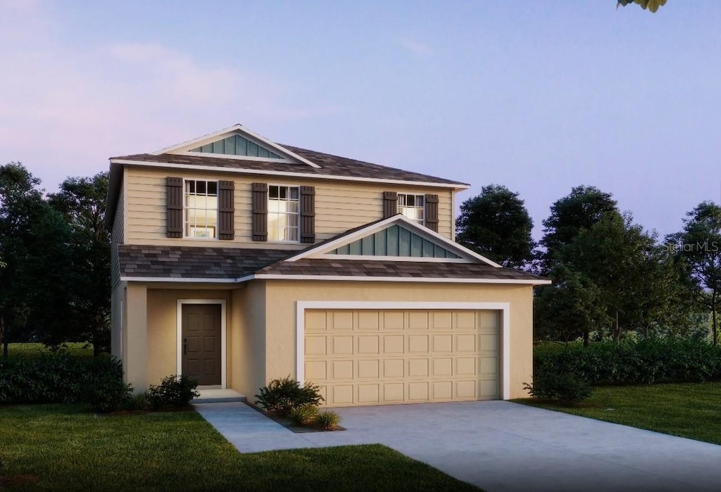 view of front of house with a garage and a lawn