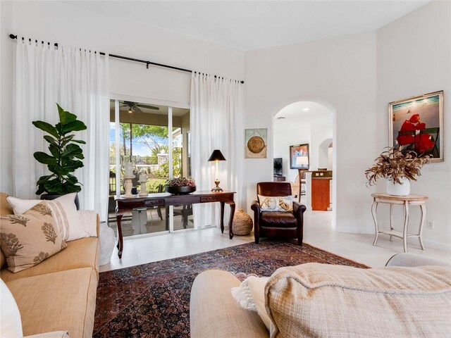 living room featuring tile floors and ceiling fan