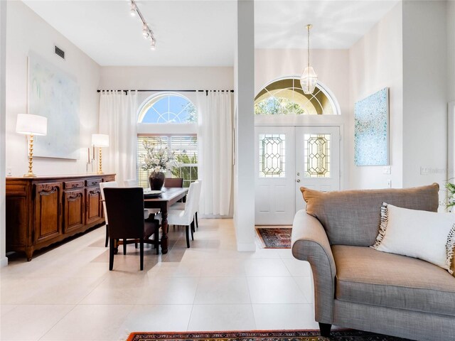 living room with track lighting and light tile flooring