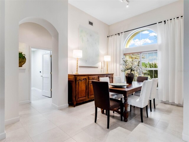 dining space featuring light tile floors