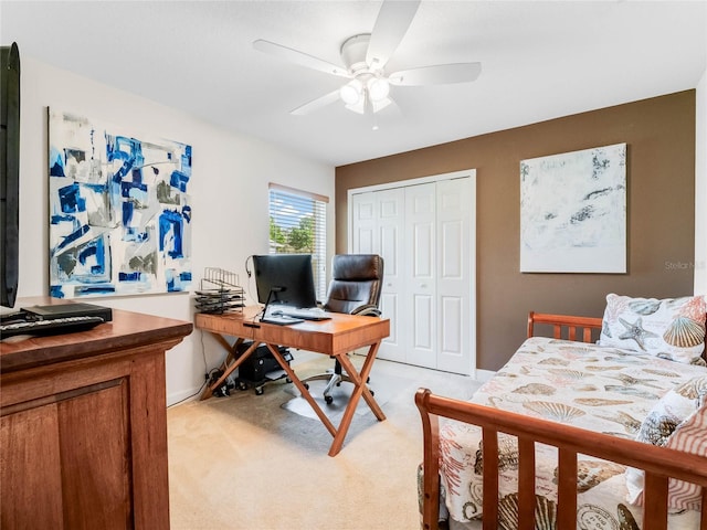 carpeted bedroom featuring a closet and ceiling fan