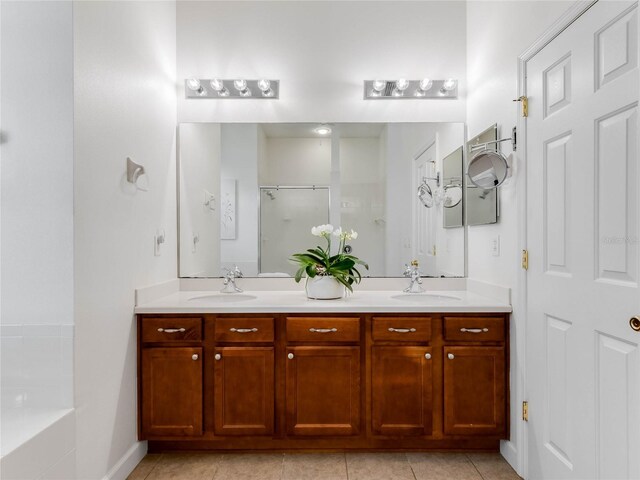 bathroom featuring dual bowl vanity, tile flooring, and a tub