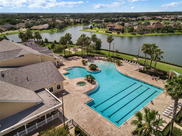 view of pool with a patio area and a water view