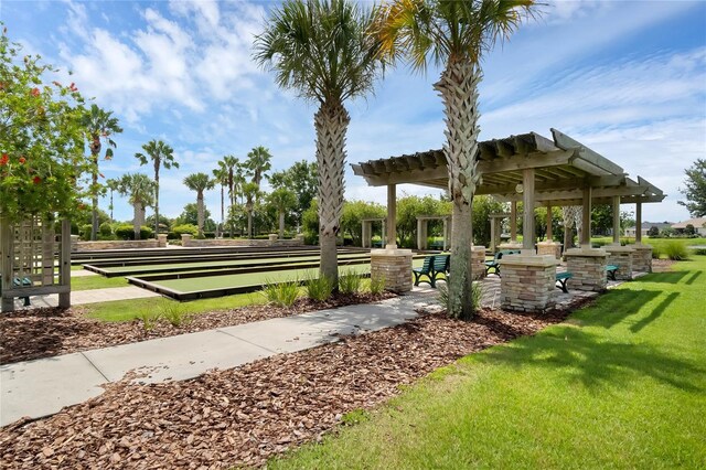 surrounding community with a pergola and a lawn