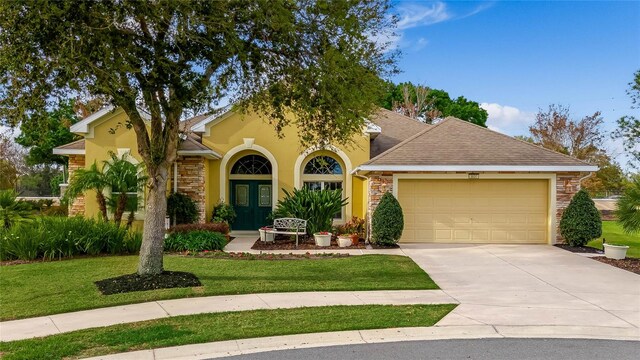 view of front facade with a front lawn and a garage