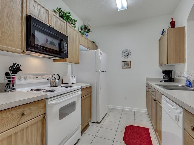 kitchen with light brown cabinetry, white appliances, sink, and light tile floors