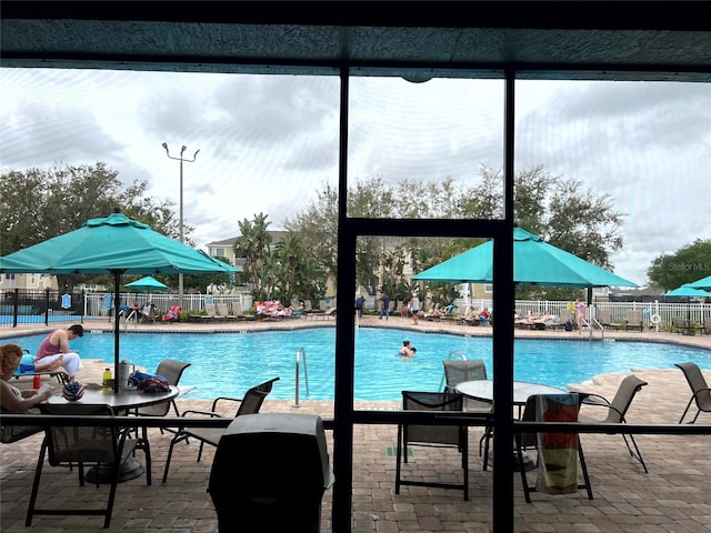 view of swimming pool featuring a patio area