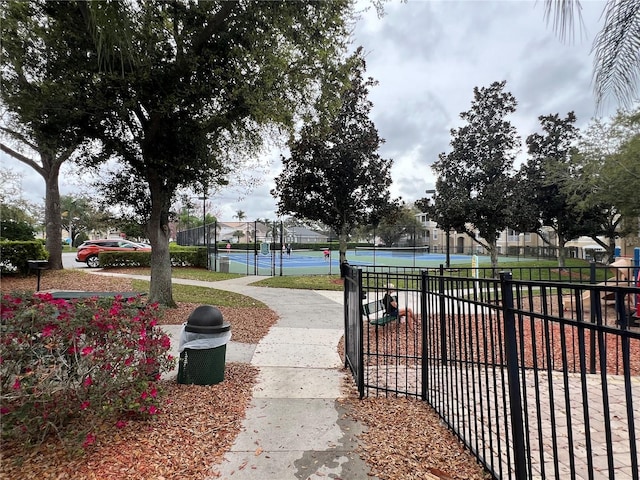 surrounding community with tennis court