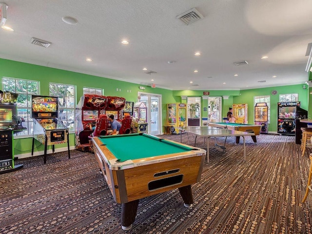 game room with a textured ceiling, pool table, crown molding, and french doors