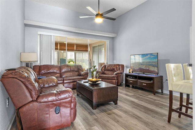 living room featuring ceiling fan and wood-type flooring