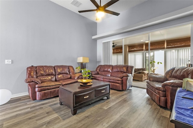 living room featuring wood-type flooring and ceiling fan