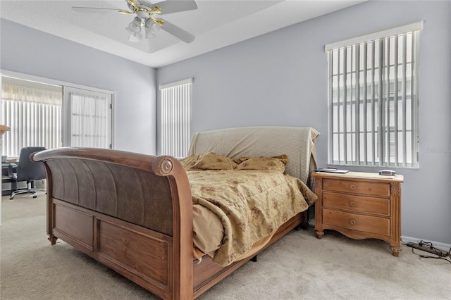 carpeted bedroom with multiple windows and ceiling fan