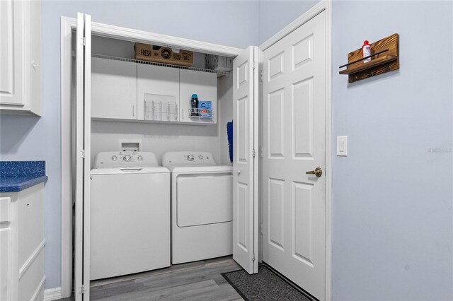 laundry room with light hardwood / wood-style flooring and washing machine and clothes dryer