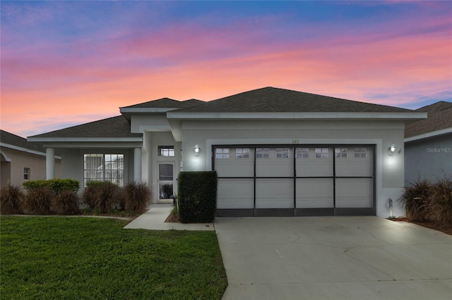 view of front of property featuring a yard and a garage