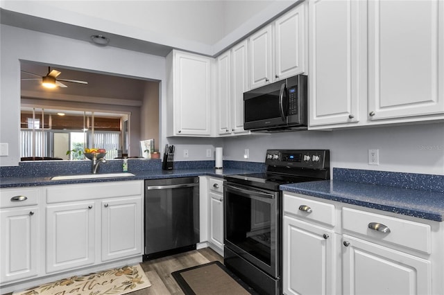 kitchen with ceiling fan, sink, dark hardwood / wood-style flooring, white cabinets, and appliances with stainless steel finishes