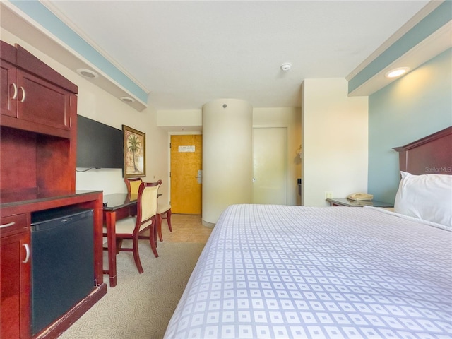 carpeted bedroom with ornamental molding and refrigerator