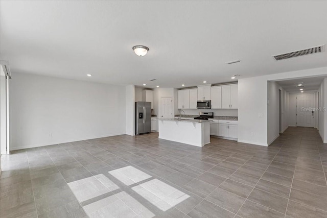 unfurnished living room featuring light tile patterned floors and sink