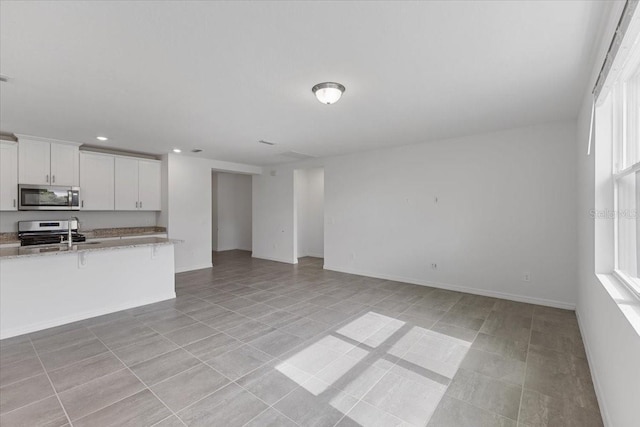 unfurnished living room featuring light tile patterned floors