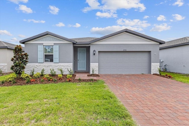 ranch-style home featuring a garage and a front lawn