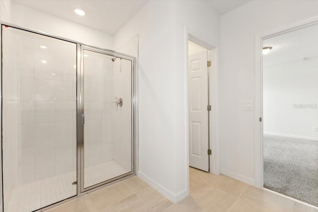 bathroom featuring walk in shower and tile flooring