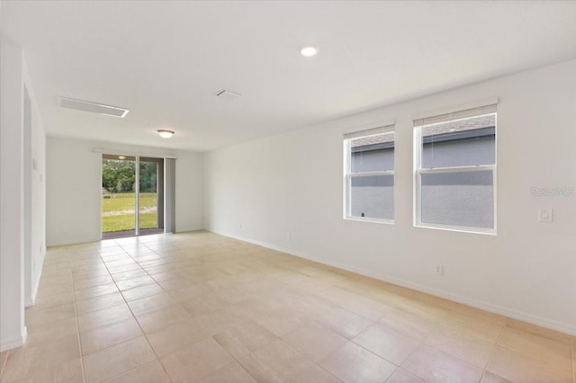 spare room featuring light tile floors