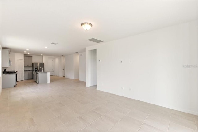 unfurnished living room with light tile floors