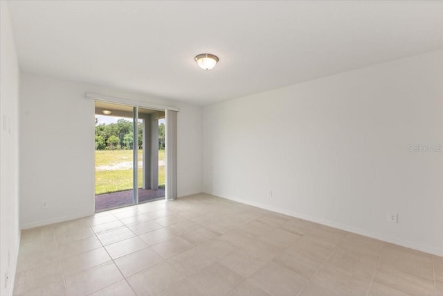 unfurnished room featuring light tile floors