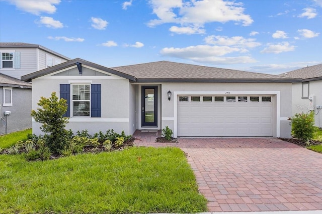 view of front of property with a garage and a front yard