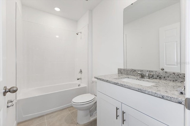 full bathroom featuring tiled shower / bath combo, vanity, tile patterned floors, and toilet