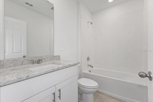 full bathroom featuring vanity, tile patterned floors, toilet, and tiled shower / bath