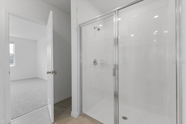 bathroom with tile patterned floors and walk in shower