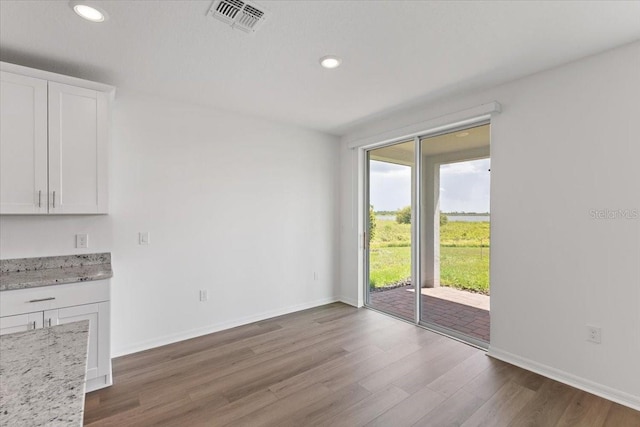 unfurnished dining area with hardwood / wood-style flooring