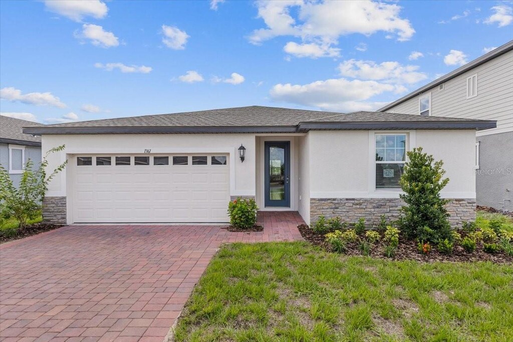 view of front of property with a garage and a front yard