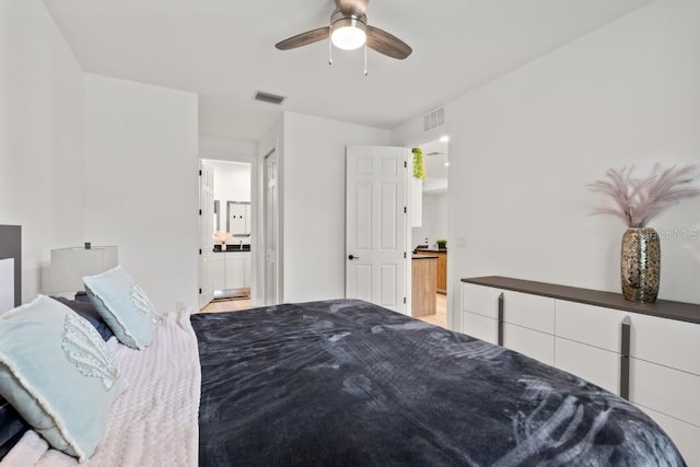 bedroom with ensuite bath and ceiling fan